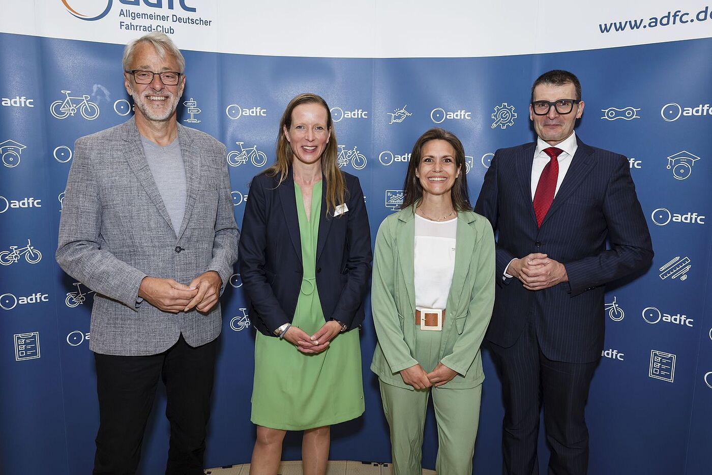 Aufnahme vor Fotowand: Von links nach rechts: ADFC-Bundesvorsitzender Frank Masurat, ADFC-Bundesgeschäftsführerin Caroline Lodemann, stellvertretende ADFC-Bundesvorsitzende Sarah Holczer, Parlamentarischer Staatssekretär Hartmut Höppner. 